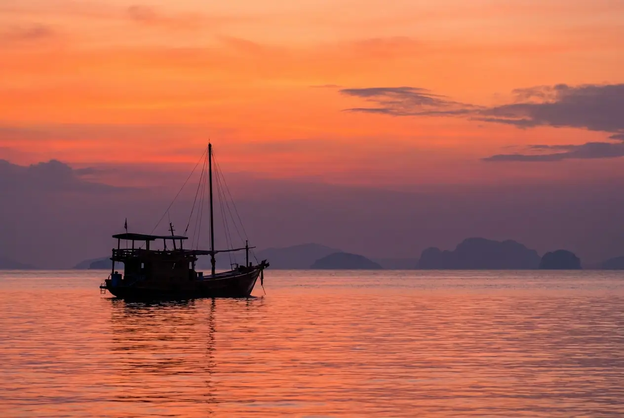 Golden sunset over calm sea and island silhouettes